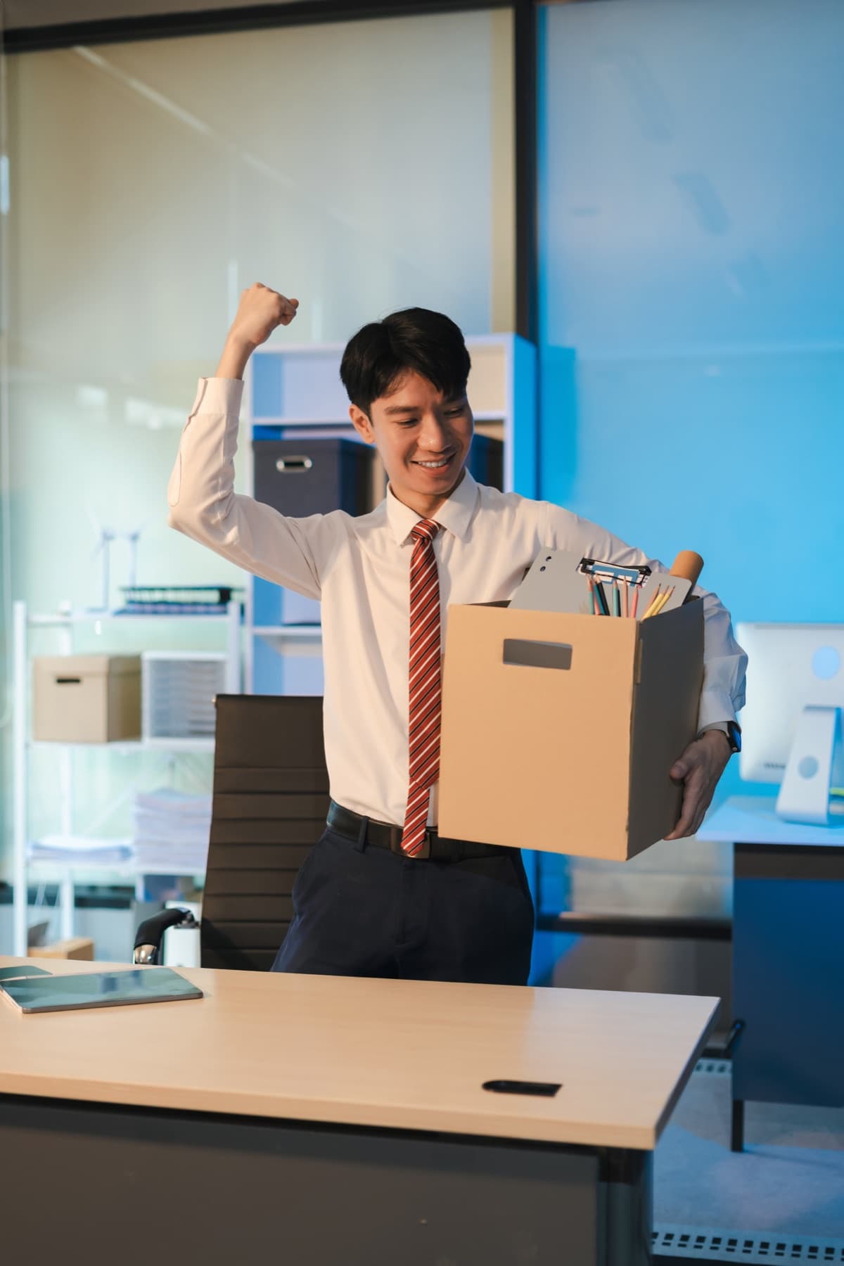 Employee carrying a moving box during a corporate relocation